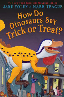 A dinosaur carrying a pumpkin bucket as kids and adults are trick-or-treating. Title reads, "How Do Dinosaurs Say Trick or Treat?.