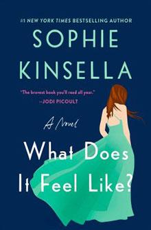 Book cover: "What Does It Feel Like?" by Sophie Kinsella, featuring a woman in a flowing green dress on a dark background.