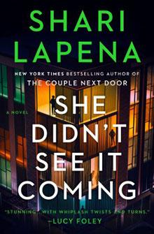 Book cover for "She Didn’t See It Coming" by Shari Lapena, with silhouettes in lit apartment windows.