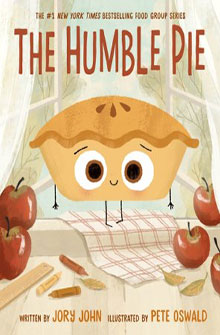 Illustrated pie with a smiling face sits on a table with apples, near a window; book cover for "The Humble Pie.