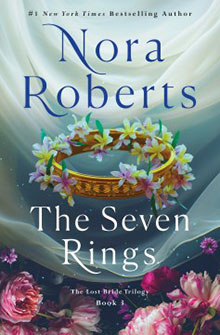 Book cover of "The Seven Rings" by Nora Roberts, featuring a golden crown with flowers on a dreamy background.