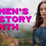 Woman in a blue dress with long hair stands in nature; bold pink text reads "Women's History Month.