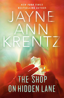 Book cover: “The Shop on Hidden Lane” by Jayne Ann Krentz, with glowing crystals in a person’s hands.