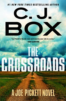 Book cover for "The Crossroads" by C.J. Box, featuring a dirt road through fields under a dramatic sky.