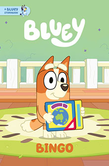 Cartoon dog Bingo sits on a rug holding a colorful book, with "Bluey" and "Bingo" written above and below.