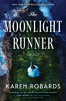 A woman in a blue dress sits on a grassy cliff by the sea under the title "The Moonlight Runner" by Karen Robards.