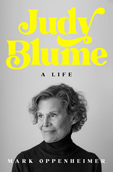 Black-and-white photo of Judy Blume, "Judy Blume: A Life" in bright yellow text above her, by Mark Oppenheimer.