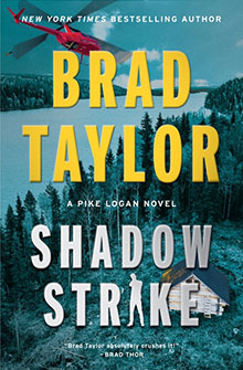 Book cover for "Shadow Strike" by Brad Taylor, featuring a red helicopter over a forest and lake, and a cabin below.