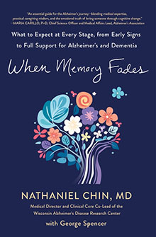 Book cover of "When Memory Fades" with a colorful floral brain illustration on a dark blue background.
