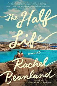 Two people sit on rocks by bright blue water under a sunny sky; text reads "The Half Life, Rachel Beanland.