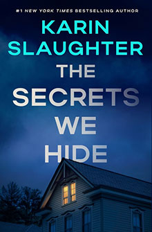 Book cover of "The Secrets We Hide" by Karin Slaughter, with a house at night and lit upstairs windows.