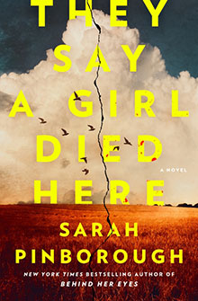 A cracked field under a cloudy sky with birds, book title "They Say a Girl Died Here" by Sarah Pinborough.