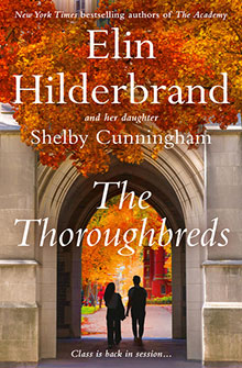 Two people walk under an archway with autumn trees; book title: The Thoroughbreds by Elin Hilderbrand.