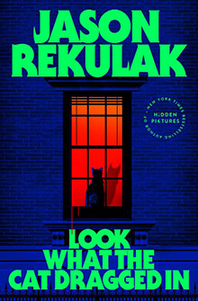 A cat sits in a window lit by orange light, with bold green and blue text for the book “Look What the Cat Dragged In.”.