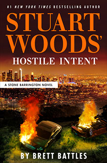 Book cover for “Hostile Intent” by Stuart Woods, featuring a burning car overlooking a city skyline at night.