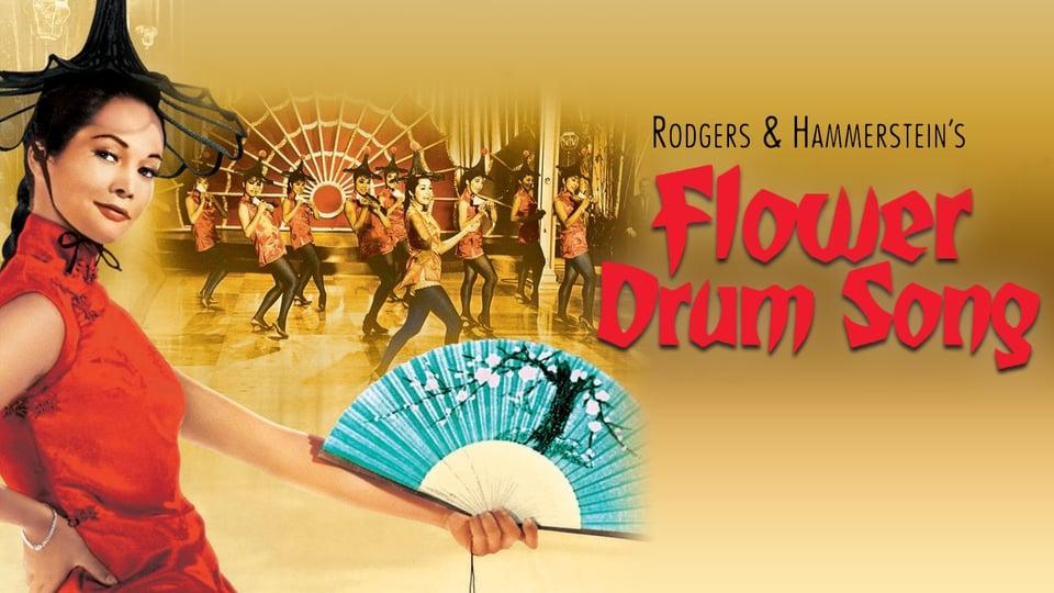 A woman in a red dress holds a fan; dancers and "Flower Drum Song" title appear in the background.