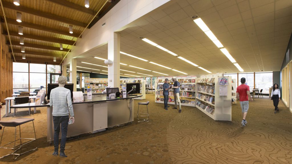 People browsing books and working at a library with modern decor, wooden ceiling, and natural light.