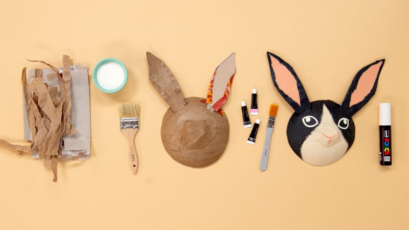 Materials and steps for crafting a bunny mask, including paper, paintbrush, glue, paper mache, and completed bunny mask.