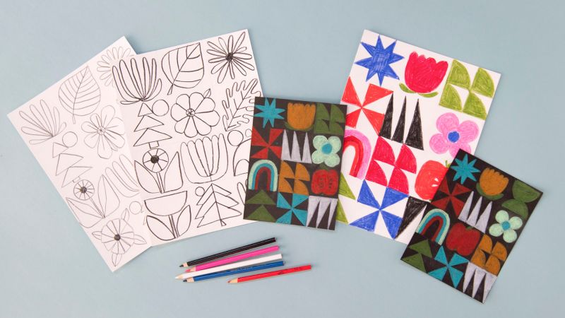 Coloring pages with geometric flower designs, completed versions, and colored pencils are arranged on a blue surface.