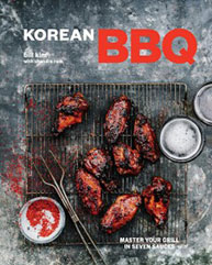 Cover of a book titled "Korean BBQ" with grilled meat, seasonings, and drinks on a cooling rack on a textured background.