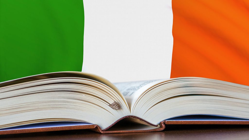 An open book with the Irish flag as the background.