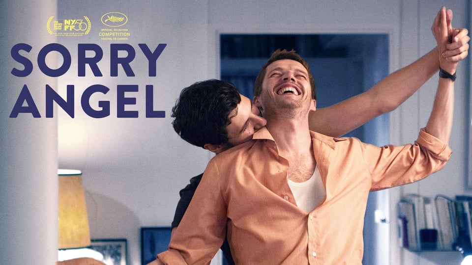 Two happy men embrace and smile in a warmly lit room. Text reads "SORRY ANGEL" with award logos above.