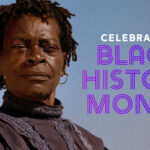 A woman in period clothing stands outside with text: Celebrating Black History Month.