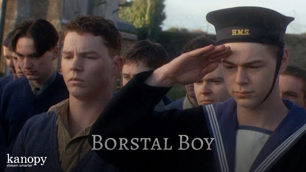 A young man in a sailor uniform salutes, standing among other solemn young men. Text reads "Borstal Boy.