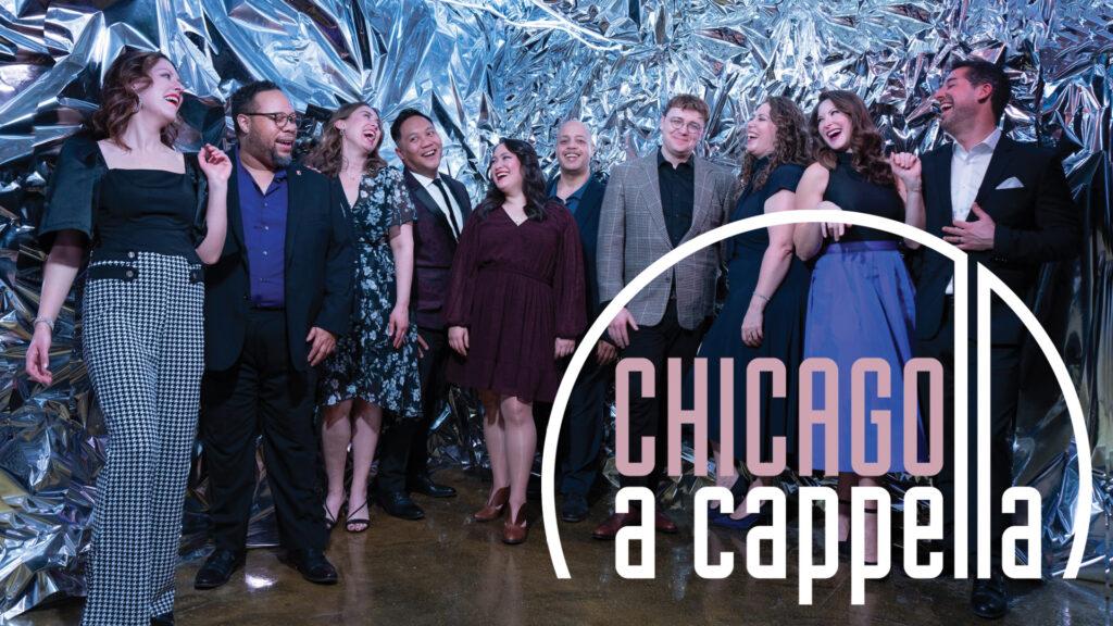 A group of people stand joyfully together in formal attire with a "Chicago a cappella" sign in front.