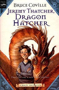 Book cover of "Jeremy Thatcher, Dragon Hatcher" showing a boy and a large dragon behind him.