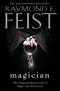 Book cover of "Magician" by Raymond E. Feist, featuring a dark background and a keyring held in gloved hands.