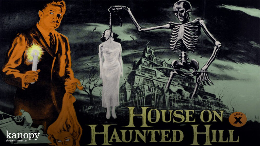 A frightened man with a candle, a skeleton, and a hanging woman in front of a spooky mansion at night.