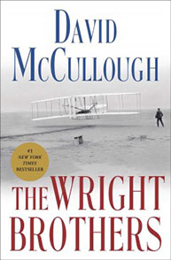 Cover of "The Wright Brothers" book by David McCullough, showing a historic airplane and a person in the background.