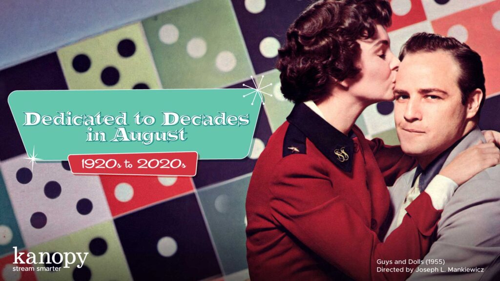 A woman kisses a man’s forehead. Retro decor and text read, “Dedicated to Decades in August: 1920s to 2020s.”.