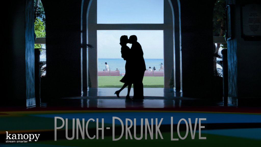 Silhouette of a couple kissing in a hallway, with a beach visible in the background.