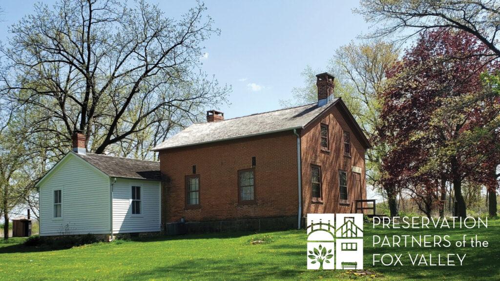 Historic brick and wood house surrounded by trees, with the Preservation Partners of the Fox Valley logo in the corner.