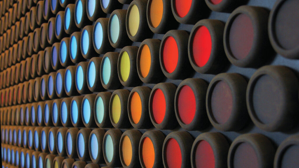 Rows of circular buttons in various colors, creating a pattern on a dark background.