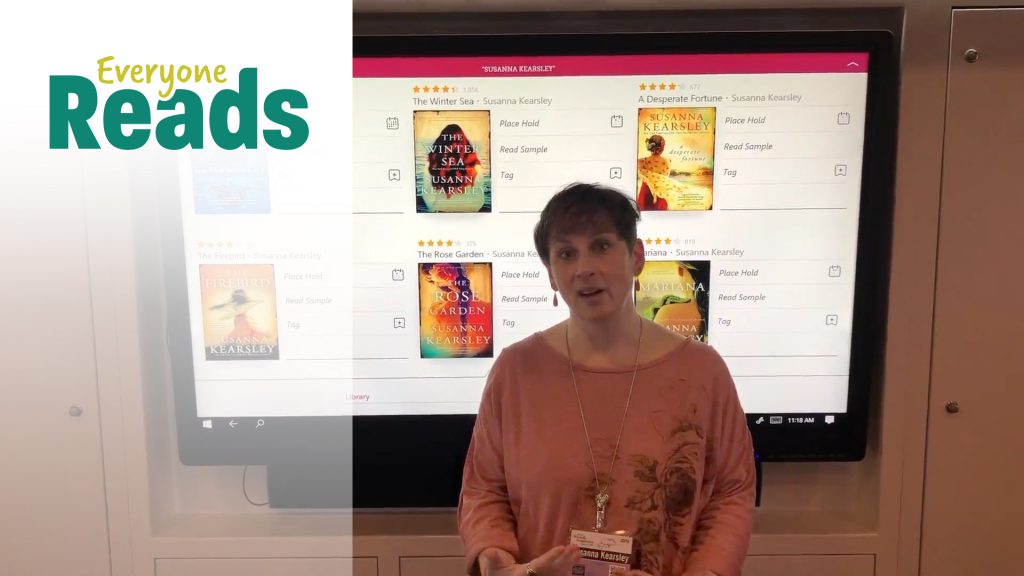 Person presenting in front of a screen displaying book titles. "Everyone Reads" text is visible on the left.