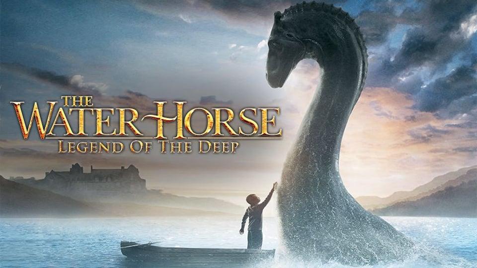 A child on a boat touches a large creature rising from the water. Text reads "The Water Horse: Legend of the Deep.