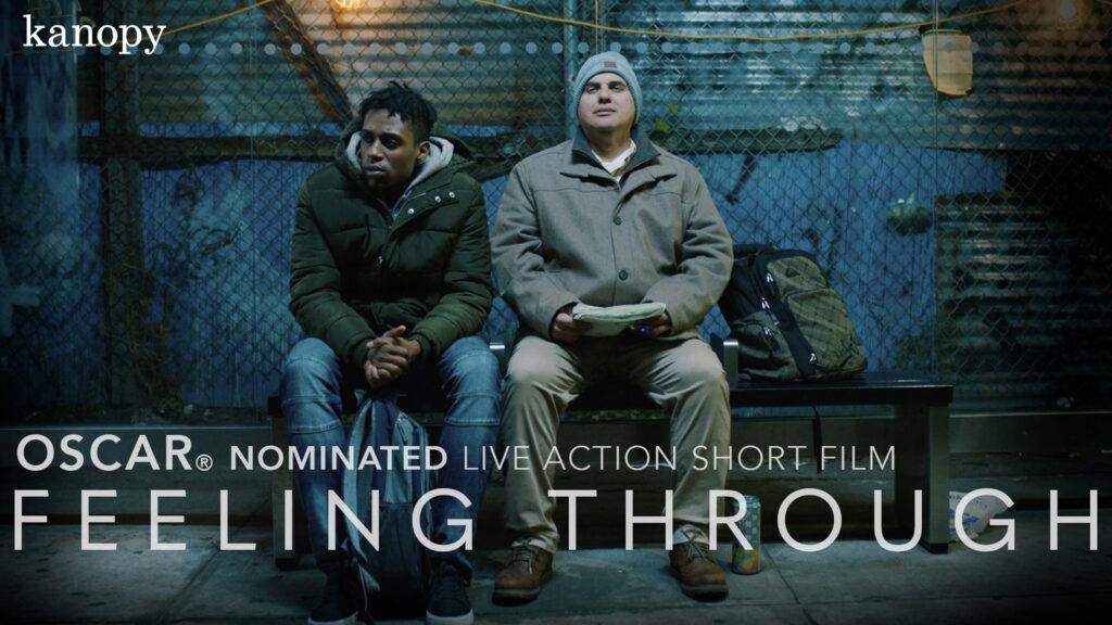 Two men sit on a bus stop bench at night; text promotes the Oscar-nominated short film "Feeling Through.