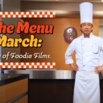 A chef in a white uniform and tall hat stands in a kitchen with text promoting foodie films on Kanopy in March.