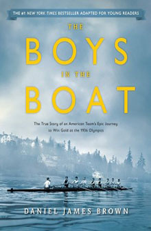 Book cover of "The Boys in the Boat" by Daniel James Brown, featuring a rowing team on a misty lake with buildings in the background.