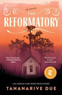 Book cover of "The Reformatory" by Tananarive Due; features a small house with tall trees against an orange sky.