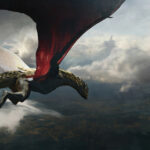 A dragon with red wings flies through a cloudy sky above a dark, scenic landscape.
