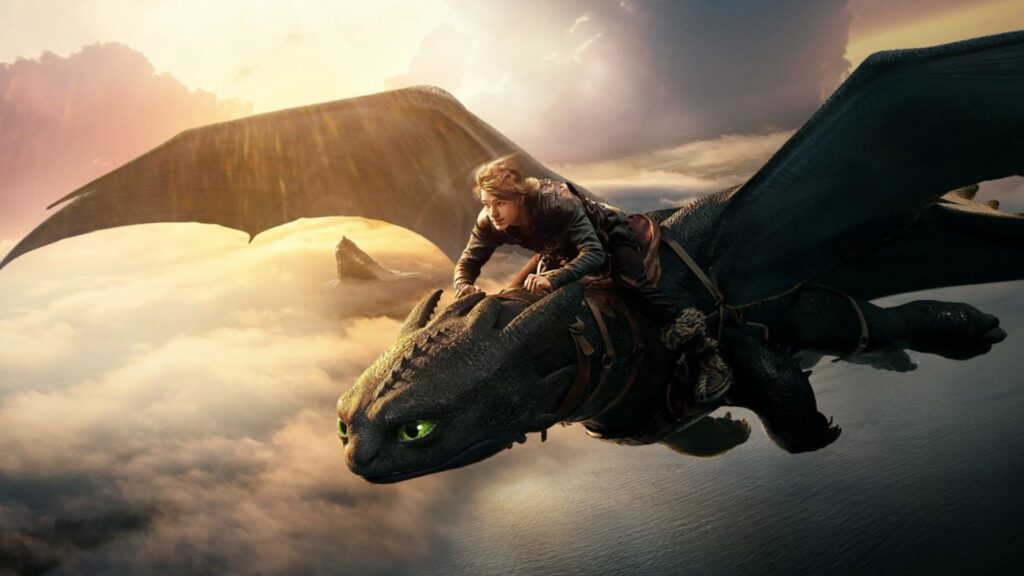 A young person rides a large black dragon with green eyes, soaring above clouds at sunset.