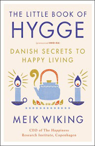 The cover of "The Little Book of Hygge: Danish Secrets to Happy Living" by Meik Wiking features candles and a teapot.