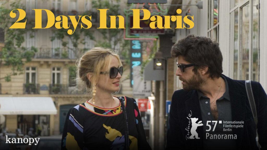 A woman and a man walk together on a city street under the text "2 Days In Paris.