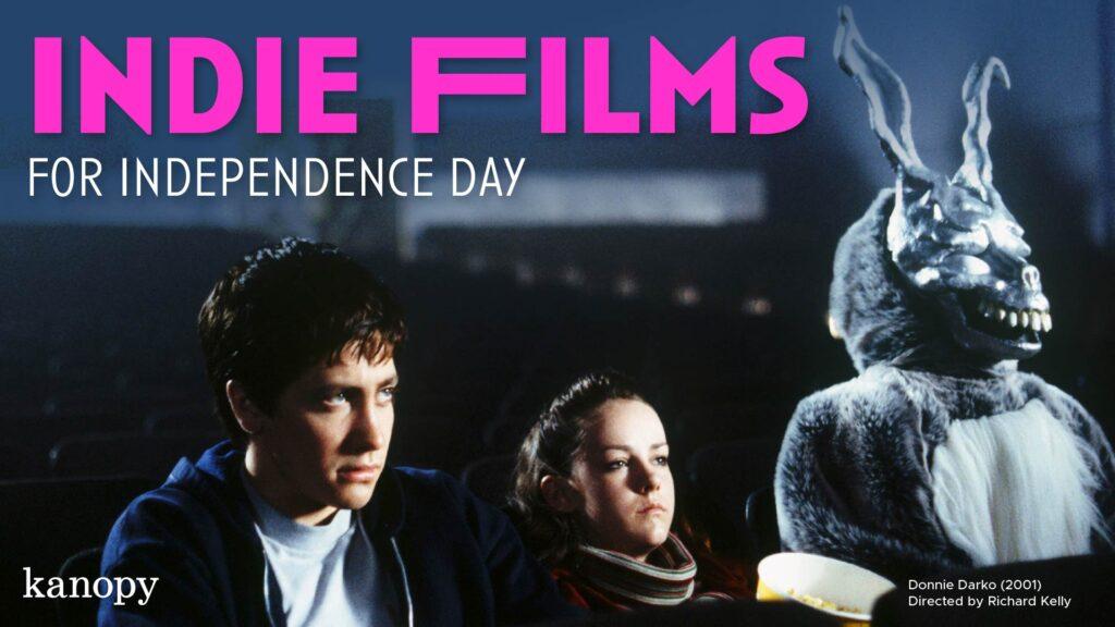 Three people, including one in a rabbit costume, sit in a dark theater with "Indie Films for Independence Day" text.