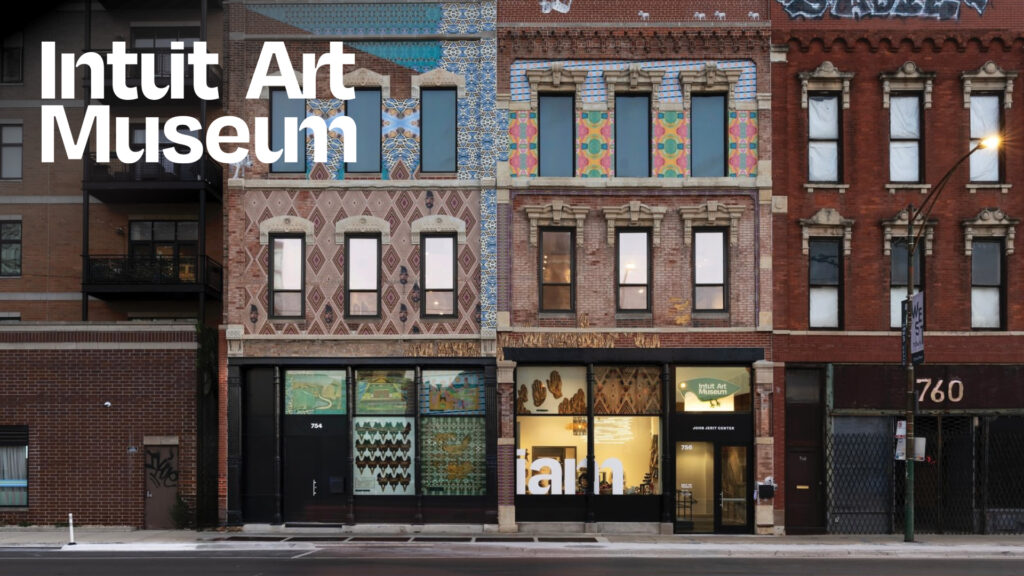 Street view of the Intuit Art Museum, showing its brick facade with colorful patterns and large front windows.