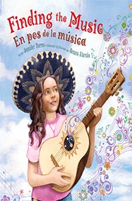 A young girl playing a guitar is on the cover of the book "Finding the Music/En pos de la música".